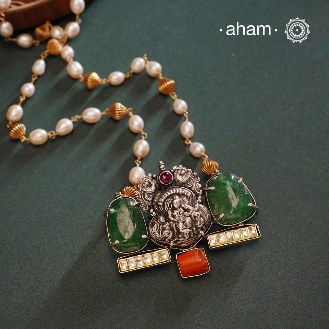 We thrive to bring alive traditional forms in new avatars. This Noori dual tone neckpiece crafted in 92.5 sterling silver with intricate Krishna nakshi work motif in the center, tumbled emeralds on either sides, kundan highlights and a unique pearl chain to elevate the entire piece. A piece perfect for intimate weddings and upcoming festive celebrations. 