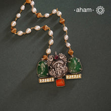 We thrive to bring alive traditional forms in new avatars. This Noori dual tone neckpiece crafted in 92.5 sterling silver with intricate Krishna nakshi work motif in the center, tumbled emeralds on either sides, kundan highlights and a unique pearl chain to elevate the entire piece. A piece perfect for intimate weddings and upcoming festive celebrations. 