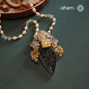 Introducing our Noori Two Tone Silver Neckpiece - a one-of-a-kind accessory crafted in 92.5 silver. This unique pendant features a beautifully carved black onyx, detailed peacocks on each side, and kundan highlights. Complete with a unique chain, this neckpiece is sure to make a statement and elevate any outfit.