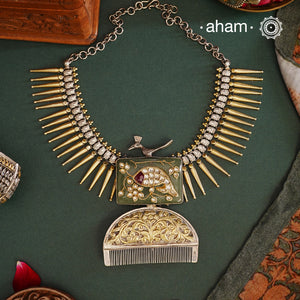 If you are looking for a truly unique piece to add to your collection, then we highly recommend this neckpiece. Made with 92.5 silver, this statement piece features a traditional Mallige Moggu base, a striking jade stone inlay, and a beautiful comb pendant. Adorned with an abstract peacock on the top, this neckpiece exudes elegance and uniqueness. A perfect piece to complement your bold style.