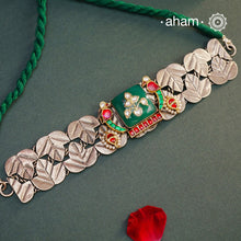 Elevate your style with the Noori Parrot Two Tone Silver Choker. This captivating piece features intricately crafted parrots and a stunning green stone, all set in 92.5 silver with two tones. Versatile and timeless, it is the perfect addition to any outfit. Invest in this modern heirloom for years to come.