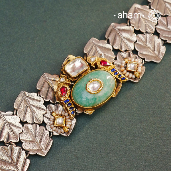 Discover the beauty of the Noori Two Tone Silver Choker. Versatile and unique, this wearable art piece is crafted in 92.5 silver with two tones and embellished with two parrots and a beautiful stone at its center. With kundan and pearl highlights, this modern heirloom will be cherished for generations.