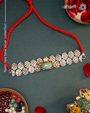 Discover the beauty of the Noori Two Tone Silver Choker. Versatile and unique, this wearable art piece is crafted in 92.5 silver with two tones and embellished with two parrots and a beautiful stone at its center. With kundan and pearl highlights, this modern heirloom will be cherished for generations.