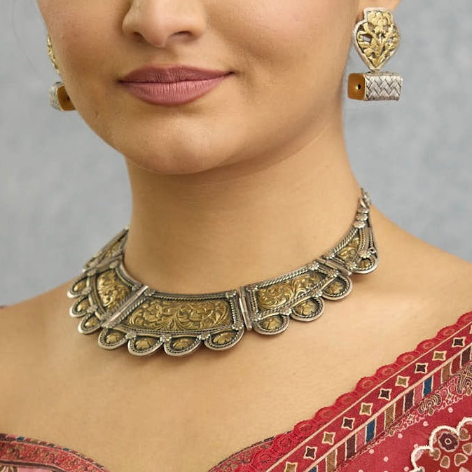 Crafted with precision and elegance, our Noori Two Tone Silver Neckpiece showcases classic chitai work in a dual tone of silver and gold. Made from high-quality 92.5 silver, this exquisite piece exudes sophistication and timeless beauty. Elevate your look with this stunning neckpiece.