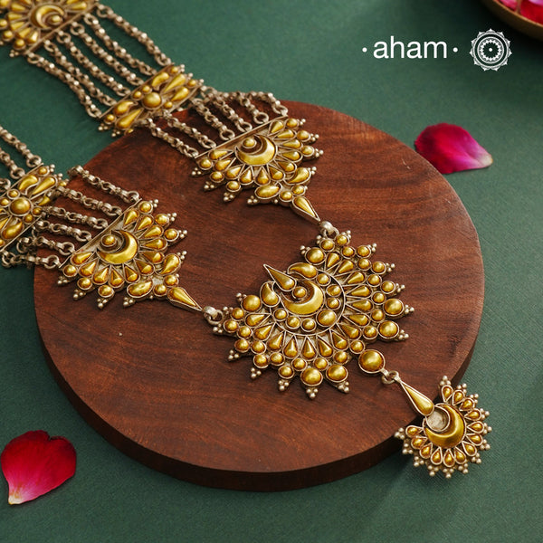 Enhance your style with the timeless elegance of the Dual Tone Silver Neckpiece. Handcrafted by skilled karigars in Barmer, Rajasthan, this earring features traditional Bandhel work, where a thin sheet of hand beaten&nbsp;22 carat gold is fused with 92.5 silver and then set on 92.5 silver using a unique wax filling technique. A classic representation of Indian craftsmanship.