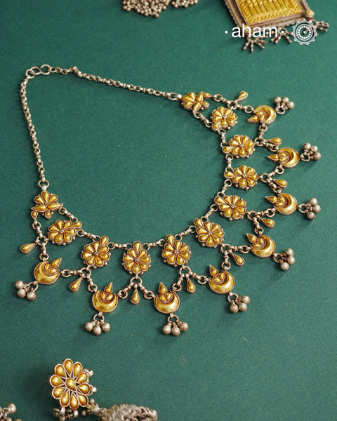 Enhance your style with the timeless elegance of the Dual Tone Silver Neckpiece. Handcrafted by skilled karigars in Barmer, Rajasthan, this earring features traditional Bandhel work, where a thin sheet of hand beaten&nbsp;22 carat gold is fused with 92.5 silver and then set on 92.5 silver using a unique wax filling technique. A classic representation of Indian craftsmanship.
