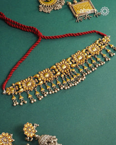 Enhance your style with the timeless elegance of the Dual Tone Silver Choker. Handcrafted by skilled karigars in Barmer, Rajasthan, this earring features traditional Bandhel work, where a thin sheet of hand beaten 22 carat gold is fused with 92.5 silver and then set on 92.5 silver using a unique wax filling technique. A classic representation of Indian craftsmanship.