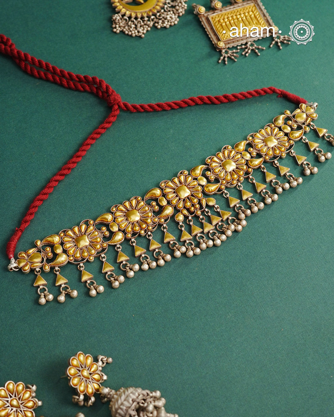Enhance your style with the timeless elegance of the Dual Tone Silver Choker. Handcrafted by skilled karigars in Barmer, Rajasthan, this earring features traditional Bandhel work, where a thin sheet of hand beaten 22 carat gold is fused with 92.5 silver and then set on 92.5 silver using a unique wax filling technique. A classic representation of Indian craftsmanship.