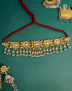 Enhance your style with the timeless elegance of the Dual Tone Silver Choker. Handcrafted by skilled karigars in Barmer, Rajasthan, this earring features traditional Bandhel work, where a thin sheet of hand beaten 22 carat gold is fused with 92.5 silver and then set on 92.5 silver using a unique wax filling technique. A classic representation of Indian craftsmanship.