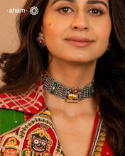 A singular artistic creation, this Nandi choker exemplifies masterful silversmithing. Executed in dual-tone silver with kundan inlay work, it presents a sophisticated composition of layered textures and chromatic variation. The piece demonstrates refined technical execution through its balanced interplay of sculptural forms and ornamental detailing. Conceived as a generational heirloom, its timeless construction and versatile aesthetic ensure enduring relevance across occasions and eras, positioning it as b