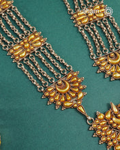 Enhance your style with the timeless elegance of the Dual Tone Silver Neckpiece. Handcrafted by skilled karigars in Barmer, Rajasthan, this earring features traditional Bandhel work, where a thin sheet of hand beaten&nbsp;22 carat gold is fused with 92.5 silver and then set on 92.5 silver using a unique wax filling technique. A classic representation of Indian craftsmanship.