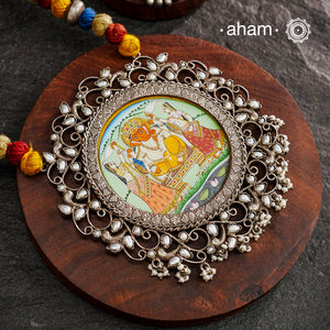 This hand-painted Ganesha neckpiece is a true piece of art. The miniature Ganesha is carefully painted by master artisans, set in silver with beautiful pearl work all around it and strung on a comfortable cotton thread. Add a touch of culture and beauty to your outfit with this unique silver neckpiece.