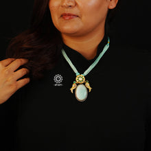 This Ira Drop Silver Neckpiece is perfect for any special occasion. Featuring a amazonite stone drop and two kundan work birds for added detail, this dual tone neckpiece is as versatile as it is stylish. Wear it short or long - the choice is yours.