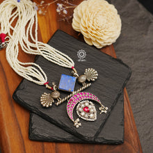 Make an 'irresistible' style statement with this one of a kind necklace! Adorn yourself with this unique peacock pendant, bedazzled with glittering kundan and topped off with the perfect pearl strands. Time to get your 'peacock pride' on!