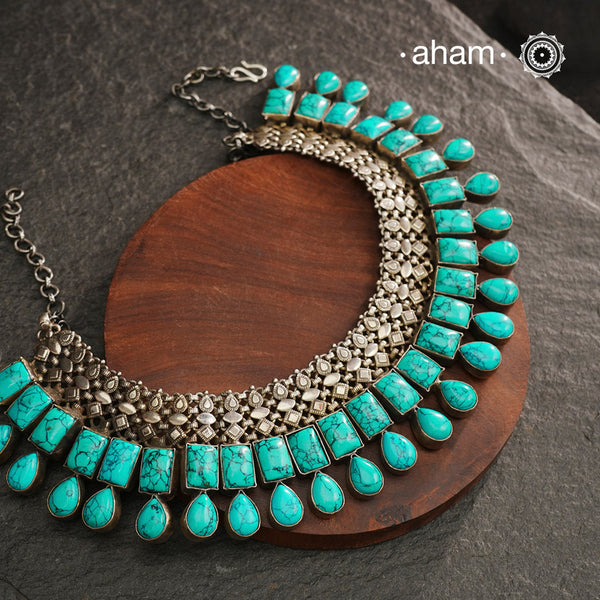 The Ira Turquoise Silver Neckpiece showcases the perfect harmony between vibrant turquoise and oxidised 92.5% sterling silver. Meticulously handcrafted, this exquisite piece offers a bold yet elegant statement, designed to elevate your look and ensure you stand out effortlessly. Ideal for those who value timeless craftsmanship and distinctive style.
