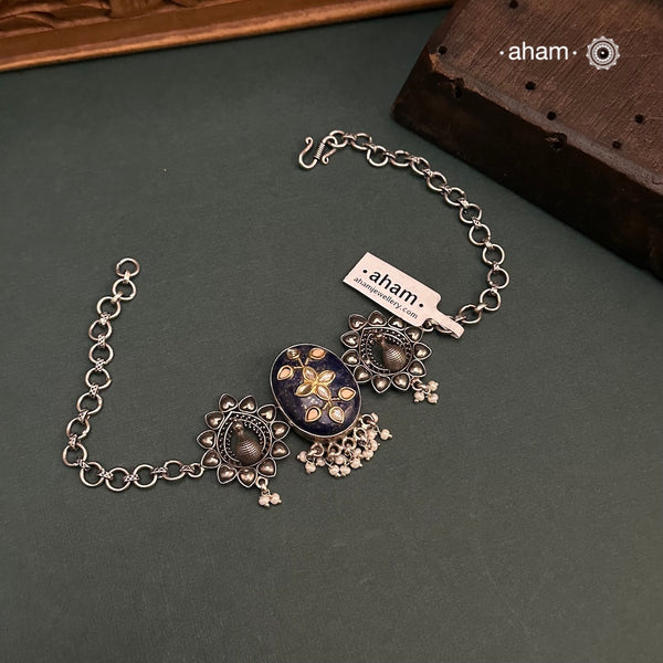 This Ira choker features a stunning lapiz center with intricate kundan inlay work, elegantly crafted in 92.5 silver. Adorn any outfit with this delicate and timeless piece. Guaranteed to add a touch of sophistication and charm to your look.