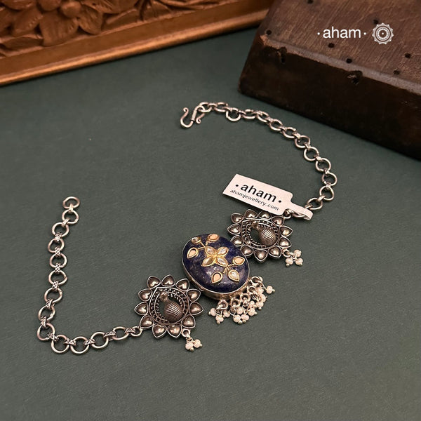 This Ira choker features a stunning lapiz center with intricate kundan inlay work, elegantly crafted in 92.5 silver. Adorn any outfit with this delicate and timeless piece. Guaranteed to add a touch of sophistication and charm to your look.