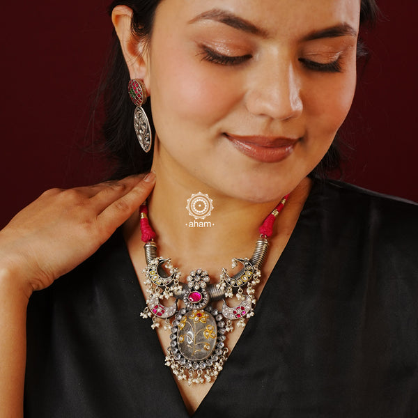 Flaunt this beautiful two tone Ira neckpiece with intricate floral work. Beautiful, handcrafted silver necklace with kundan and semi precious stones. Looks great with both ethnic and western outfits.
