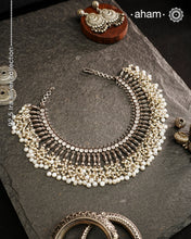 This 92.5 silver Ira neckpiece exemplifies understated elegance through meticulous craftsmanship. Fresh water pearl beads delicately laces the sterling silver, creating a sophisticated piece that sits gracefully below the neck. A testament to minimalist design principles and artisanal jewellery-making techniques.