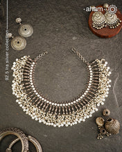This 92.5 silver Ira neckpiece exemplifies understated elegance through meticulous craftsmanship. Fresh water pearl beads delicately laces the sterling silver, creating a sophisticated piece that sits gracefully below the neck. A testament to minimalist design principles and artisanal jewellery-making techniques.