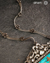 Make a bold statement with the Ira Turquoise Silver Neckpiece! This stunning piece features a vibrant turquoise stone set in silver with intricate inlay work and kundan all around it.&nbsp; Delicate flowers decorate the chain, all crafted in 92.5 silver. Elevate your style and stand out from the crowd with this unique necklace.