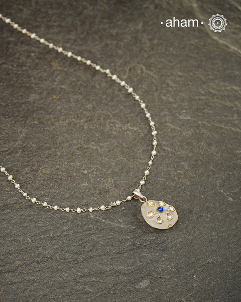 Crafted in 92.5 sterling silver, this elegant pendant celebrates the timeless beauty of natural gemstones and fine craftsmanship. A faceted rose quartz takes centre stage, adorned with delicate kundan-inspired inlay work and finished with a striking lapis lazuli accent that adds a touch of rich colour and contrast.

Suspended from a dainty freshwater pearl chain, the pendant is graceful, lightweight, and effortlessly versatile. Whether worn on its own for a subtle statement or layered with other favourites,