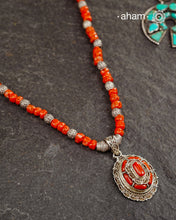 The Himalayan Coral Silver Neckpiece is expertly crafted to reflect the unique design traditions of the Himalayan foothills and Tibetan region. Featuring the pendant with vibrant coral and stones set in sterling silver and strung with raw coral beads interspersed with intricately detailed silver beads, this piece captures the rich cultural heritage and natural beauty of these high-altitude areas. Its distinctive style offers a timeless elegance.
