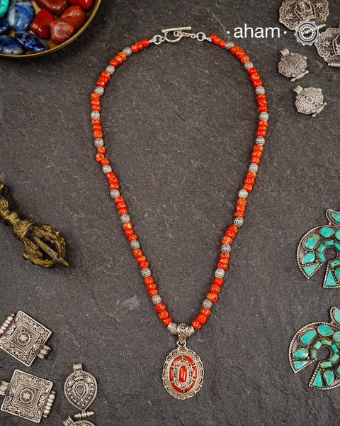 The Himalayan Coral Silver Neckpiece is expertly crafted to reflect the unique design traditions of the Himalayan foothills and Tibetan region. Featuring the pendant with vibrant coral and stones set in sterling silver and strung with raw coral beads interspersed with intricately detailed silver beads, this piece captures the rich cultural heritage and natural beauty of these high-altitude areas. Its distinctive style offers a timeless elegance.
