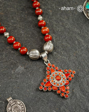The Himalayan Silver Neckpiece is expertly crafted to reflect the unique design traditions of the Himalayan foothills and Tibetan region. Featuring a pendant with vibrant coral stones set in sterling silver and strung in red jasper beads along with silver beads, this piece captures the rich cultural heritage and natural beauty of these high-altitude areas. Its distinctive style offers a timeless elegance, perfect for collectors and connoisseurs who value authentic craftsmanship and region-specific artistry.