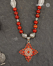 The Himalayan Silver Neckpiece is expertly crafted to reflect the unique design traditions of the Himalayan foothills and Tibetan region. Featuring a pendant with vibrant coral stones set in sterling silver and strung in red jasper beads along with silver beads, this piece captures the rich cultural heritage and natural beauty of these high-altitude areas. Its distinctive style offers a timeless elegance, perfect for collectors and connoisseurs who value authentic craftsmanship and region-specific artistry.