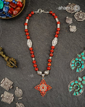 The Himalayan Silver Neckpiece is expertly crafted to reflect the unique design traditions of the Himalayan foothills and Tibetan region. Featuring a pendant with vibrant coral stones set in sterling silver and strung in red jasper beads along with silver beads, this piece captures the rich cultural heritage and natural beauty of these high-altitude areas. Its distinctive style offers a timeless elegance, perfect for collectors and connoisseurs who value authentic craftsmanship and region-specific artistry.