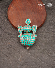 A beautiful Pendant with turquoise chips embeded. Crafted in 92.5 silver.