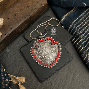 Statement silver pendant handcrafted in 92.5 silver with intricate floral chitai work from Rajasthan, comes with coral and pearl stone highlights. Wear it with a long silver chain or with cotton thread, to pair with your formal Indian outfits.  Does not include Chain.