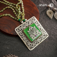 The Ira Silver Neckpiece features masterful chitai work with precise silver cutwork that sits on a luminous green center stone. The pendant is complemented by a strand of carefully selected semi-precious stone beads, enhancing its visual complexity. This exceptional piece demonstrates superior silversmithing techniques while offering a sophisticated aesthetic that transitions effortlessly from traditional to contemporary settings.