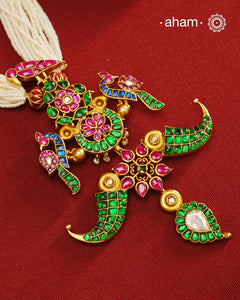 Make a style statement with this gold polish festive neckpiece. Crafted using traditional techniques in silver with kundan floral, peacock and tiger tooth motifs. Perfect for intimate weddings and upcoming festive celebrations.