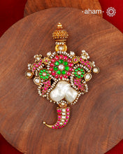 An exquisite interplay of elements comes together in this one-of-a-kind pendant. Featuring a luminous baroque pearl at the centre, framed by peacocks on either side, delicate fish motifs, and a tiger tooth detail at the base, it is crafted in 92.5 silver with a gold polish finish. Accented with deep pink and green kundan work and finished with delicate pearl detailing, this pendant is designed to make a distinctive statement. Works great with a Hasli