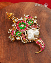 An exquisite interplay of elements comes together in this one-of-a-kind pendant. Featuring a luminous baroque pearl at the centre, framed by peacocks on either side, delicate fish motifs, and a tiger tooth detail at the base, it is crafted in 92.5 silver with a gold polish finish. Accented with deep pink and green kundan work and finished with delicate pearl detailing, this pendant is designed to make a distinctive statement. Works great with a Hasli&nbsp;