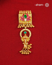 A striking pendant inspired by traditional symbolism and intricate craftsmanship. Featuring a beautifully detailed Ganesha motif suspended below a lotus adorned with deep pink and green kundan work, this piece celebrates artistry in every detail. Crafted in 92.5 silver with a rich gold polish finish, delicate ghungroo accents add movement and charm, making it a distinctive statement for festive and occasion wear..