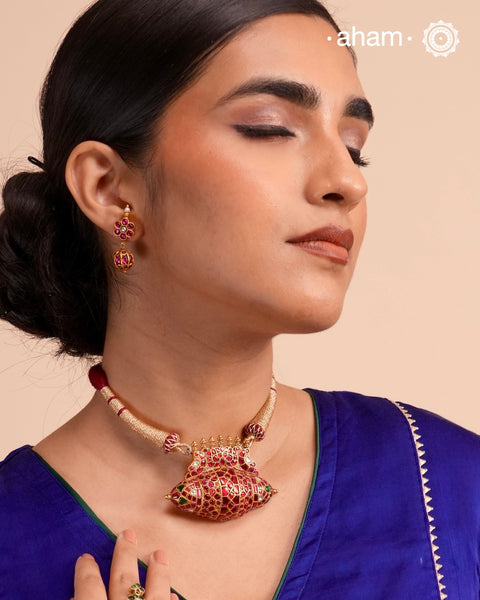 Festive 92.5 sterling silver pendant with beautiful nature inspired motifs. Handcrafted by skilful artisans, enhanced with semi precious stones and gold polish. Comes with a golden cord.Chain not included.