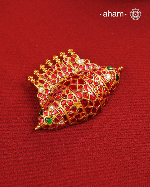 Festive 92.5 sterling silver pendant with beautiful nature inspired motifs. Handcrafted by skilful artisans, enhanced with semi precious stones and gold polish. Comes with a golden cord.Chain not included.