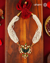 Fine Kundan work pendant in 92.5 silver with gold polish. Beautiful carved green stone in the center. Comes with faux pearl beads.