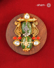 A harmonious composition of heritage-inspired elements, this statement pendant brings together tumble emeralds, coral accents, kundan highlights, and intricately detailed motifs in a beautifully layered form. The sculptural design, enhanced with delicate silver detailing and a rich gold polish finish, evokes the charm of vintage jewellery while feeling strikingly distinctive. Crafted in 92.5 silver, this pendant is perfect for adding an artistic, conversation-worthy touch to festive and occasion wear.