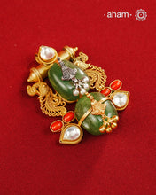 A harmonious composition of heritage-inspired elements, this statement pendant brings together tumble emeralds, coral accents, kundan highlights, and intricately detailed motifs in a beautifully layered form. The sculptural design, enhanced with delicate silver detailing and a rich gold polish finish, evokes the charm of vintage jewellery while feeling strikingly distinctive. Crafted in 92.5 silver, this pendant is perfect for adding an artistic, conversation-worthy touch to festive and occasion wear.