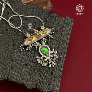 Beautiful vintage silver amulet with hints of gold tone, glass studs and a beautiful vintage green glass drop come together to make this stunning pendant. Pair it with a hasli or a long chain of your choice.&nbsp;
