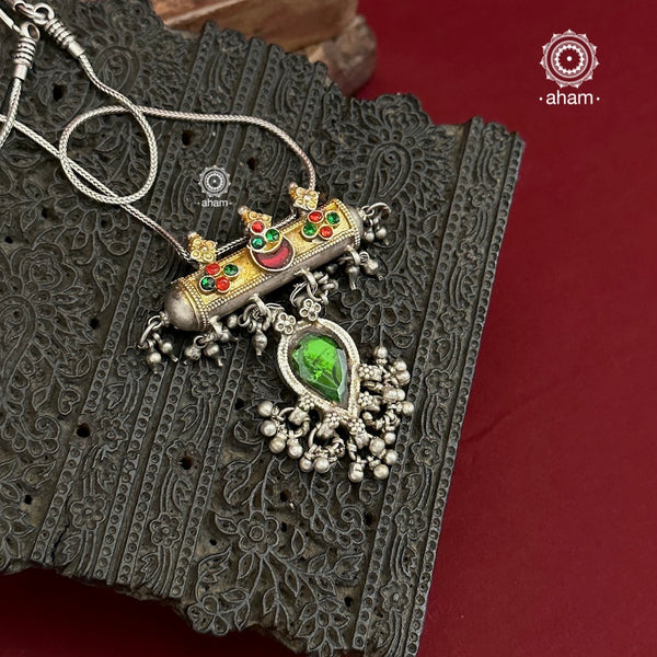 Beautiful vintage silver amulet with hints of gold tone, glass studs and a beautiful vintage green glass drop come together to make this stunning pendant. Pair it with a hasli or a long chain of your choice. 