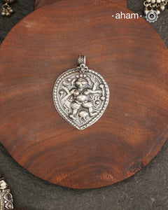 Discover the charm of traditional craftsmanship with our Handmade 92.5 Sterling Silver Kal Bhairav Amulet Pendant. Expertly crafted using the thapi (stamp die) technique, this pendant reflects the age-old artistry of India’s tribal communities. Known by various names like Kavach, Mandaliya, Patri, and Kathla, amulet pendants have long been cherished as symbols of passive worship—a way to keep your deity, Kuldevta, or Kuldevi close to your heart. Traditionally worn on a cord or silver chain.