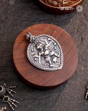 Discover the charm of traditional craftsmanship with our Handmade 92.5 Sterling Silver Kal Bhairav Amulet Pendant. Expertly crafted using the thapi (stamp die) technique, this pendant reflects the age-old artistry of India’s tribal communities. Known by various names like Kavach, Mandaliya, Patri, and Kathla, amulet pendants have long been cherished as symbols of passive worship—a way to keep your deity, Kuldevta, or Kuldevi close to your heart. Traditionally worn on a cord or silver chain.