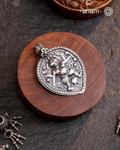 Discover the charm of traditional craftsmanship with our Handmade 92.5 Sterling Silver Kal Bhairav Amulet Pendant. Expertly crafted using the thapi (stamp die) technique, this pendant reflects the age-old artistry of India’s tribal communities. Known by various names like Kavach, Mandaliya, Patri, and Kathla, amulet pendants have long been cherished as symbols of passive worship—a way to keep your deity, Kuldevta, or Kuldevi close to your heart. Traditionally worn on a cord or silver chain.