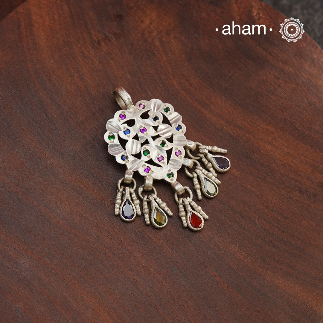Beautiful chiali work silver pendant that comes with colourful glass stone highlights.traditional craftsmanship at its finest.