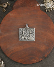 Discover the charm of traditional craftsmanship with our Handmade Ganesh Lakshmi 92.5 Sterling Silver Pendant.Expertly crafted using the thapi (stamp die) technique, this pendant reflects the age-old artistry of India’s tribal communities. Known by various names like Kavach, Mandaliya, Patri, and Kathla, amulet pendants have long been cherished as symbols of passive worship—a way to keep your deity, Kuldevta, or Kuldevi close to your heart. Traditionally worn on a cord or silver chain, this striking amulet 